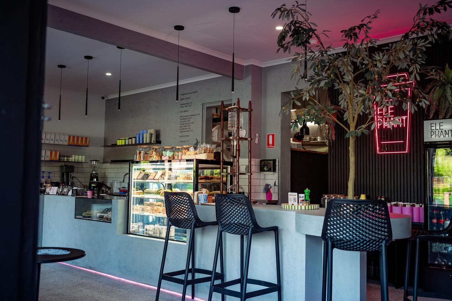 The welcoming Elephant Café coffee bar, with plants and pink neon lighting