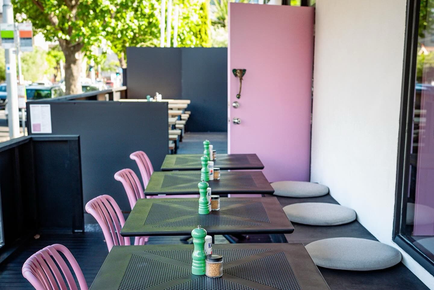 Pink chairs and outdoor tables on the café terrace