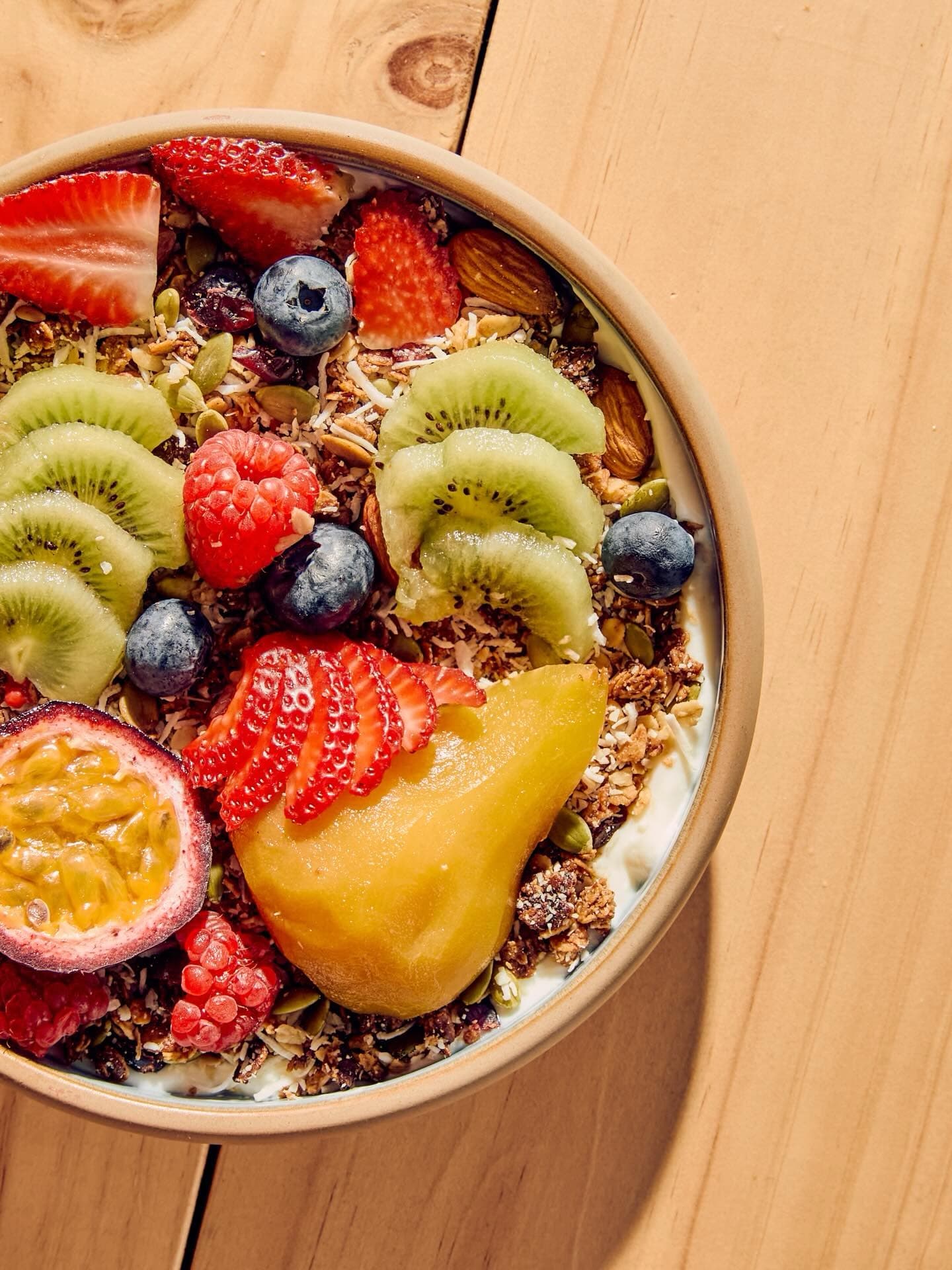 Granola with yoghurt and colourful fresh fruit